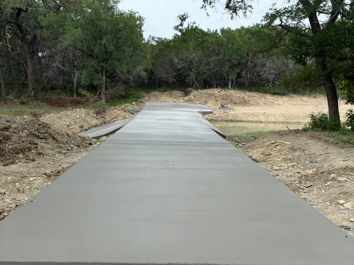 Poured concrete low-water crossing on a rural ranch road in the Texas Hill Country