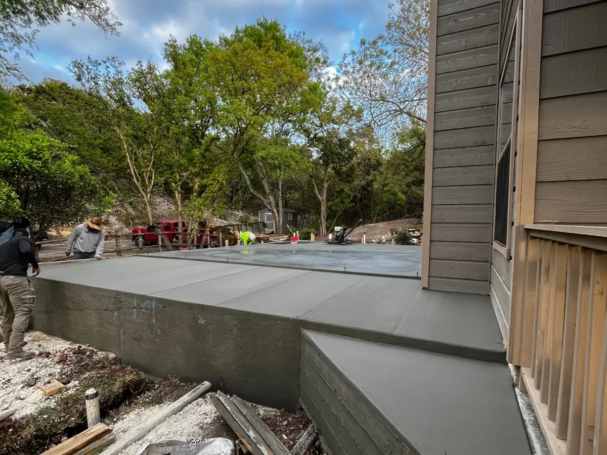 Covered concrete patio slab poured along the back of a Texas Hill Country home