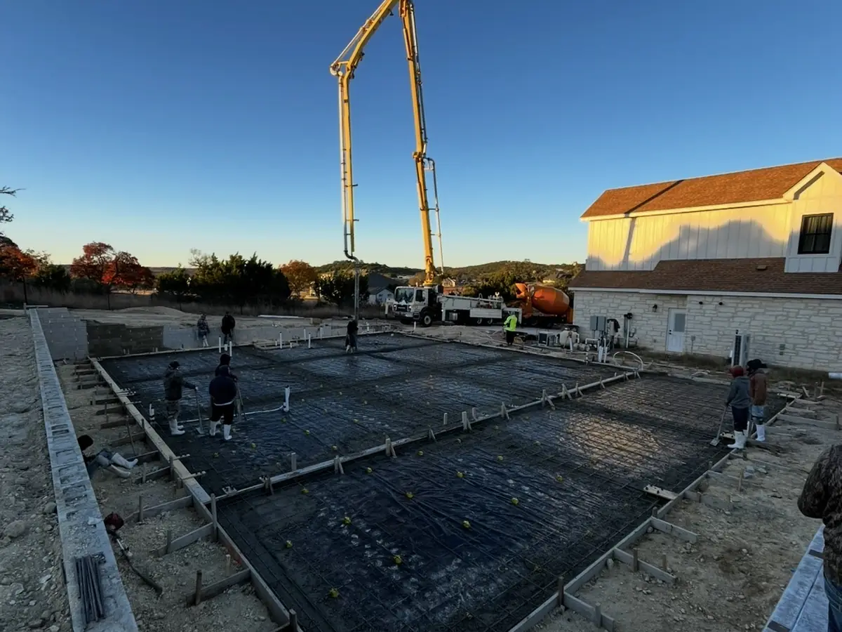 Concrete crew placing a new residential home slab foundation near Kerrville, Texas
